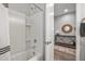 Bathroom with white tile shower/tub and wood-look floors at 22491 E Mewes Rd, Queen Creek, AZ 85142
