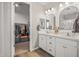 Bathroom features a walk-in closet, a double sink vanity, and modern lighting at 22491 E Mewes Rd, Queen Creek, AZ 85142