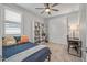 Comfortable bedroom features a ceiling fan, bookshelf, and neutral color scheme at 22491 E Mewes Rd, Queen Creek, AZ 85142