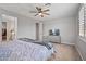 Bedroom features a ceiling fan, TV on a dresser, and a walk-in closet entrance at 22491 E Mewes Rd, Queen Creek, AZ 85142