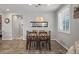 The dining room features wood floors and a modern light fixture at 22491 E Mewes Rd, Queen Creek, AZ 85142
