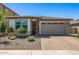 Inviting single-story home featuring desert landscaping and a two-car garage at 22491 E Mewes Rd, Queen Creek, AZ 85142