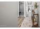 Bright hallway featuring wood-look floors, neutral paint, and modern decor at 22491 E Mewes Rd, Queen Creek, AZ 85142