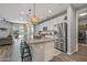 The open-concept kitchen features an island with pendant lights and stainless-steel appliances at 22491 E Mewes Rd, Queen Creek, AZ 85142