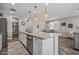 A kitchen featuring a large island with sink, dining room, and stainless-steel appliances at 22491 E Mewes Rd, Queen Creek, AZ 85142