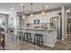 Modern kitchen with stainless steel appliances, a large island with seating, and pendant lighting at 22491 E Mewes Rd, Queen Creek, AZ 85142