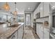 An open-concept kitchen with stainless steel appliances, a large island, and views into the living room at 22491 E Mewes Rd, Queen Creek, AZ 85142
