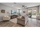 Inviting living room features a ceiling fan, sliding glass doors to the patio, and comfortable seating at 22491 E Mewes Rd, Queen Creek, AZ 85142