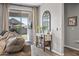 Living room with sliding glass doors and a decorative mirror next to a console table at 22491 E Mewes Rd, Queen Creek, AZ 85142