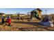 Community playground with a slide, a toy tractor, and various climbing structures at 22491 E Mewes Rd, Queen Creek, AZ 85142