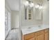 Bathroom featuring a double sink vanity, large mirrors and neutral-toned walls at 2424 E Fairfield St, Mesa, AZ 85213