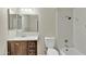 Bathroom featuring white tiling, quartz countertop, and dark wood cabinets at 2424 E Fairfield St, Mesa, AZ 85213