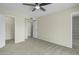 This bedroom features a ceiling fan and closet, with neutral colored walls and carpet at 2424 E Fairfield St, Mesa, AZ 85213