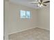 Bright bedroom with neutral walls, tile flooring, and a large window letting in light at 2424 E Fairfield St, Mesa, AZ 85213