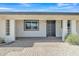 A welcoming front porch with decorative columns and a stylish, dark-colored front door at 2424 E Fairfield St, Mesa, AZ 85213