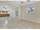 A bright living room leads into the kitchen with new tile flooring and lots of light at 2424 E Fairfield St, Mesa, AZ 85213