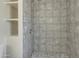 Modern bathroom shower with tiled surround and built in shelving at 2424 E Fairfield St, Mesa, AZ 85213