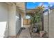 Side yard with a brick wall and lattice covered with vines at 2424 E Fairfield St, Mesa, AZ 85213