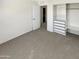 Bright bedroom with carpet, an open closet with built-ins, and an ensuite bathroom at 25038 N 40Th Ave, Phoenix, AZ 85083