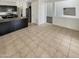 Open-concept kitchen and living area features neutral tiling, stainless steel appliances and an island at 25038 N 40Th Ave, Phoenix, AZ 85083