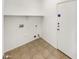 Laundry room with tile flooring, shelf, and hookups for washer and dryer at 25038 N 40Th Ave, Phoenix, AZ 85083