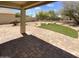 Covered patio area with brick pavers, artificial turf, and landscaped backyard at 25038 N 40Th Ave, Phoenix, AZ 85083