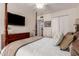 Cozy bedroom features a four-poster bed, dark wood dresser and white closet doors at 2630 E Dolphin Ave, Mesa, AZ 85204