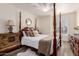 Traditional bedroom with four-poster bed, dresser and a rounded window with shutters at 2630 E Dolphin Ave, Mesa, AZ 85204