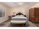 Relaxing bedroom featuring ceiling fan, hardwood floors and a patterned quilt on the bed at 2630 E Dolphin Ave, Mesa, AZ 85204