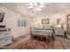 Bright bedroom with a gold frame bed, shuttered windows, and neutral decor at 2630 E Dolphin Ave, Mesa, AZ 85204