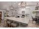 Open concept kitchen with island seating, white cabinetry, and stainless steel appliances at 2630 E Dolphin Ave, Mesa, AZ 85204