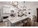 Bright white kitchen featuring a large island with marble countertops and seating at 2630 E Dolphin Ave, Mesa, AZ 85204