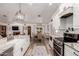 Eat-in kitchen showcases an island sink, white cabinets, and stainless steel appliances at 2630 E Dolphin Ave, Mesa, AZ 85204