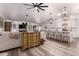 Open-concept living room and kitchen with white cabinets and wood-style floors at 2630 E Dolphin Ave, Mesa, AZ 85204