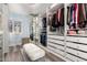 Light and airy walk-in closet with white shelving, storage and a comfortable bench at 2630 E Dolphin Ave, Mesa, AZ 85204