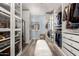 Bright walk-in closet features custom shelving and cabinets providing ample storage at 2630 E Dolphin Ave, Mesa, AZ 85204