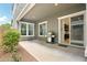 Covered back patio with a built-in grill, sliding glass doors, and easy access to the kitchen at 2942 E Appaloosa Rd, Gilbert, AZ 85296
