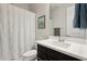Bright bathroom featuring a clean white vanity, a framed mirror, and a shower with patterned curtain at 2942 E Appaloosa Rd, Gilbert, AZ 85296