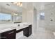Elegant bathroom showcasing a dual sink vanity, walk-in shower, and luxurious finishes at 2942 E Appaloosa Rd, Gilbert, AZ 85296