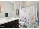 Well-lit bathroom with modern vanity and shower featuring a decorative floral shower curtain at 2942 E Appaloosa Rd, Gilbert, AZ 85296
