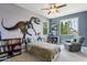 Whimsical bedroom featuring a unique dinosaur wall decal and playful decor elements at 2942 E Appaloosa Rd, Gilbert, AZ 85296