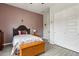 Cozy bedroom featuring a mauve accent wall, wood-look tile flooring, and a double door closet at 2942 E Appaloosa Rd, Gilbert, AZ 85296