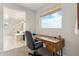 Bright home office with a modern wooden desk, comfortable chair, and natural light at 2942 E Appaloosa Rd, Gilbert, AZ 85296