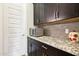 Kitchen area with granite countertops, dark cabinetry, and stainless steel appliances at 2942 E Appaloosa Rd, Gilbert, AZ 85296