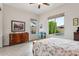 Bright main bedroom features neutral walls, wood-look tile floor, and an idyllic backyard pool view at 2942 E Appaloosa Rd, Gilbert, AZ 85296