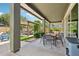 Spacious covered patio area with dining table, outdoor seating, and a view of the backyard at 2942 E Appaloosa Rd, Gilbert, AZ 85296