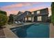 Beautiful outdoor pool area with elegant lighting, comfortable lounge seating, and landscaped surroundings at 2942 E Appaloosa Rd, Gilbert, AZ 85296