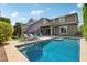 Inviting backyard oasis featuring a sparkling pool, patio, and lush landscaping perfect for entertaining at 2942 E Appaloosa Rd, Gilbert, AZ 85296