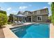 Inviting backyard pool area with lounge chairs, covered patio, and a well-maintained garden at 2942 E Appaloosa Rd, Gilbert, AZ 85296