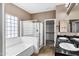 Bathroom featuring a bathtub, glass shower, dual sinks, and a walk-in closet at 3033 W Redwood Ln, Phoenix, AZ 85045